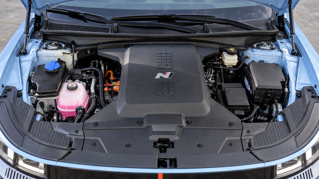 Representative N-family covered electric front compartment, with its fitted central cover, orange high-voltage cabling and separate service components.